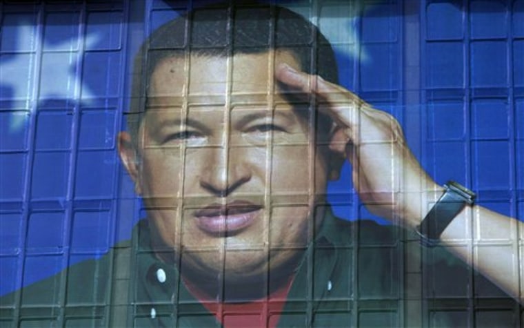An image of Venezuela’s President Hugo Chavez covers the headquarters of the state-run oil company in Caracas, Venezuela, Thursday, March 1, 2012. Chavez on Thursday made his first live communication with news media since undergoing surgery this week to remove a possibly cancerous tumor. Chavez has been in Cuba since last Friday to have a growth removed in the same part of the pelvis where a larger, malignant tumor was extracted last year. (AP Photo/Ariana Cubillos)